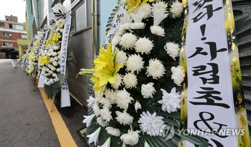 지난 7월 27일 종로구 서울특별시 중부교육지원청 앞에 6개월 전 극단적 선택을 한 서울 사립초등학교 교사 A씨를 추모하는 화환이 놓여있다. [연합뉴스]